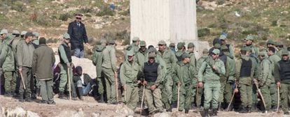 Moroccan police and auxiliary forces hold back a group of sub-Saharans near Melilla.