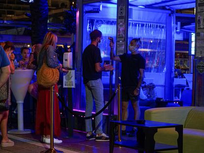 A temperature check is carried out at the door of a bar in Marbella, in southern Spain.