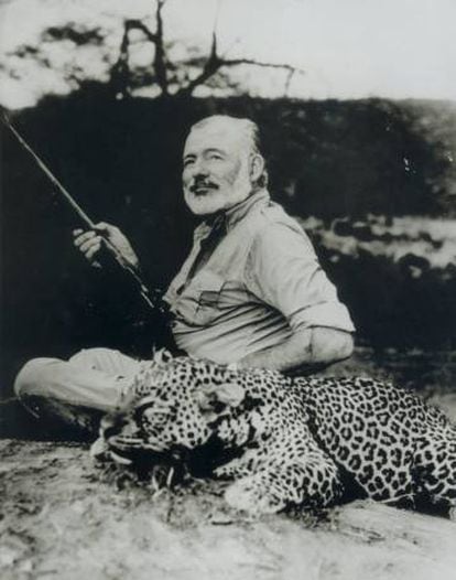 Ernest Hemingway stands beside a dead leopard in 1953.