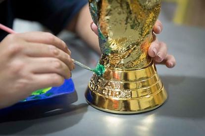 Pantano touches up the finishing on her World Cup trophy replica. 