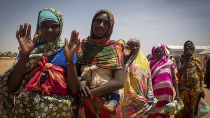Women who have been forcibly displaced from West Darfur wait to receive food packages, in a refugee camp in Adre, in Chad, on the border with Sudan, on April 12, 2024.