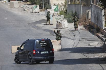 Israeli soldiers guard the northern entrance to the Palestinian city of Hebron in the West Bank on October 8.