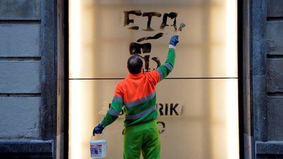 A worker cleans graffiti in support of Basque terror group ETA.