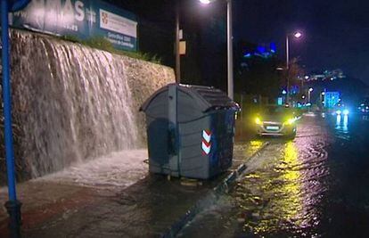 Water pouring down into a street in Alicante.