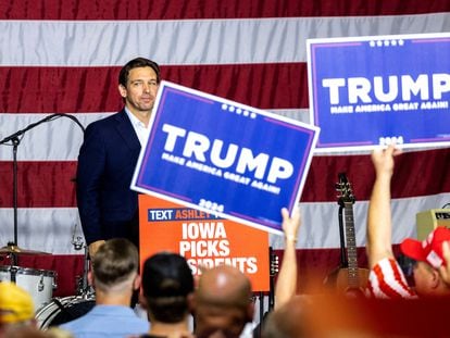 Ron DeSantis looks into the crowd after speaking as supporters of former President Donald Trump hold up signs during the Ashley's BBQ Bash fundraiser at Hawkeye Downs in Cedar Rapids, Iowa, August 6, 2023.