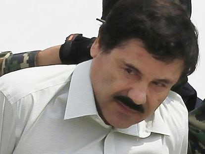 Joaquin 'El Chapo' Guzman is escorted by soldiers during a presentation at the navy's airstrip in Mexico City in 2011.