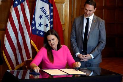 Arkansas Gov. Sarah Huckabee Sanders signs a bill requiring age verification before creating a new social media account as Sen. Tyler Dees, R-Siloam Springs, looks on during a signing ceremony, Wednesday, April 12, 2023, at the state Capitol in Little Rock, Ark.