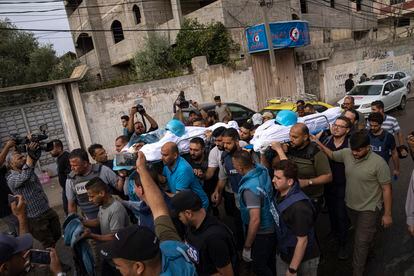 Palestinians, including some journalists, carry the bodies of two Palestinian reporters, Mohammed Soboh and Said al-Tawil, who were killed by an Israeli airstrike in Gaza City, Tuesday, Oct. 10, 2023. 