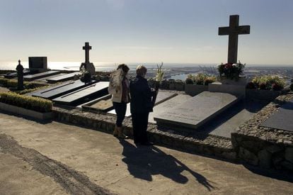 Mourners attend a cemetery on All Saint&#039;s day to pay their respects. 