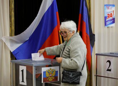 A voter casts her ballot at a polling station during local elections held by the Russian-installed authorities in the course of Russia-Ukraine conflict