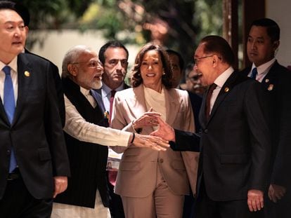 Indian PM Narendra Modi shakes hands with Malaysian counterpart Anwar Ibrahim in front of U.S. Vice President Kamala Harris in Jakarta.