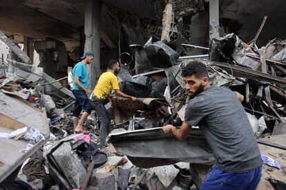 People sift through the rubble of a destroyed building following Israeli strikes on Al-Shatee camp in Gaza City on October 28, 2023.