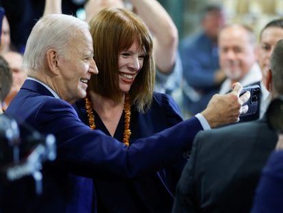 U.S. President Joe Biden takes a selfie with a person in Auburn, Maine, on July 28, 2023.