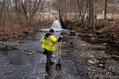 Ron Fodo, Ohio EPA Emergency Response, looks for signs of fish and also agitates the water in Leslie Run creek to check for chemicals that have settled at the bottom following a train derailment that is causing environmental concerns on February 20, 2023 in East Palestine, Ohio.