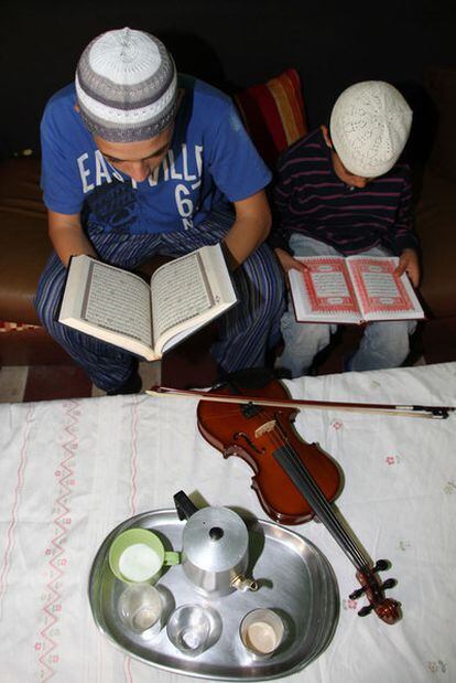 Two children read the Koran in their home in Melilla. Some students at schools in the enclave are refusing to take music classes.