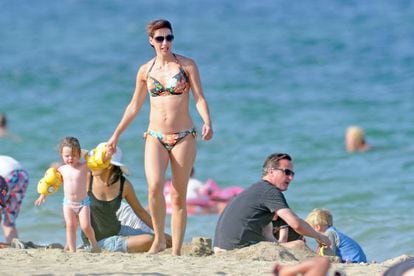 David Cameron relaxes on a Mallorca beach with his wife, Samantha, and daughter, Florence. 