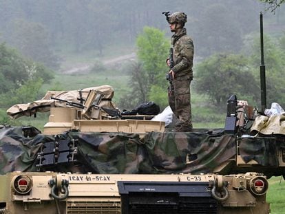 A US soldier stands on a US Army M1A2 Abrams tank during the Combined Resolve 18 exercise at the Hohenfels trainings area, southern Germany, on May 11, 2023.