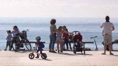 Families enjoying the seaside promenade in Barcelona on Sunday.