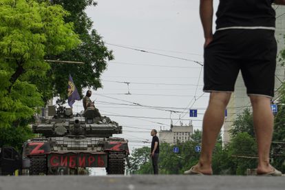 Wagner mercenaries block a Rostov street with a tank marked 'Siberia'. 