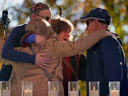 People hug after lighting a candle in memory of one of 11 worshippers killed four years ago when a gunman opened fire at the Tree of Life synagogue in Squirrel Hill, in Pittsburgh, on October 27, 2022.
