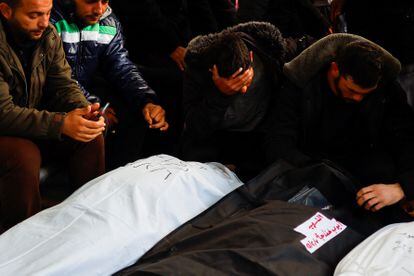 Mourners react next to the bodies of Palestinians, two of whom died of natural causes and the rest were killed in Israeli strikes, in Rafah, Gaza Strip, February 7, 2024.