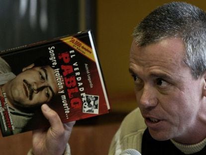 “Popeye” holding up a book about cartel chief Pablo Escobar.
