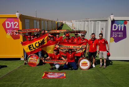 Spanish fans pose by the dormitories on the outskirts of the Qatari capital. 