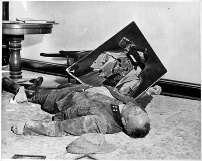 Walter Doenicke, a major in the Volkssturm national militia, lies on the floor of Leipzig city hall after committing suicide. 