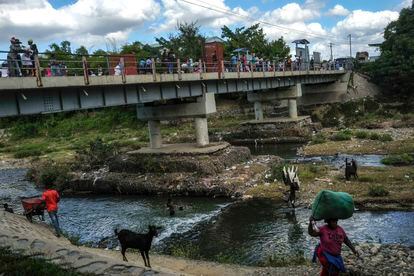 People bathe in the Massacre River, named for a bloody battle between Spanish and French colonizers in the 1700s, on the border with Haiti in Ouanaminthe, Dominican Republic, Nov. 19, 2021