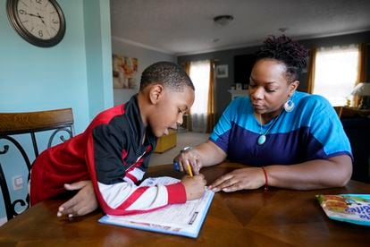 Tamela Ensrud helps her son, Christian, 7, with his homework at their home on Monday, November 21, 2022, in Nashville, Tennessee.