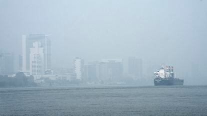 A freighter passes through the Detroit River as smoke fills the sky reducing visibility to Windsor, Ontario, on June 28, 2023, as seen from Detroit.