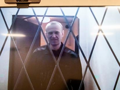 Russian opposition leader Alexei Navalny is seen on a TV screen as he appears in a video link provided by the Russian Federal Penitentiary Service from the courtroom in Kovrov, Russia. Jan. 10, 2024.