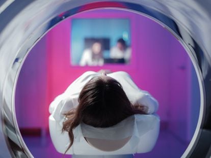 A young woman undergoes a CT scan.