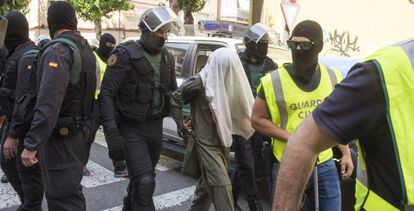 Civil Guard officers with a jihadist suspect in the Catalan city of Lleida.