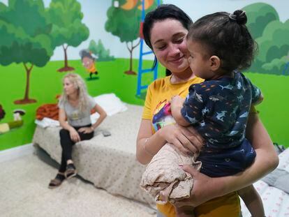 Isabel Bembow Tamayo holds Liam Centeno, 1, in the school classroom that is converted into a bedroom for her family, on February 21, 2023, in Hialeah, Florida.