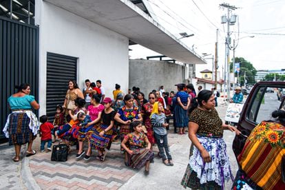 Dozens of people wait by Guatemala City's international airport for flights bringing back deportees from the U.S.; May 2023