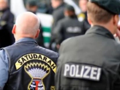A still from a YouTube video showing members of Satudarah MC being watched by German police.