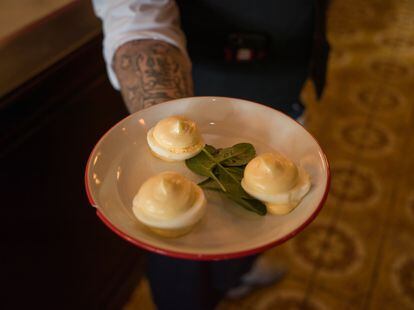 A waiter holds a typical plate of eggs with mayonnaise at the Bouillon Republique, in Paris.