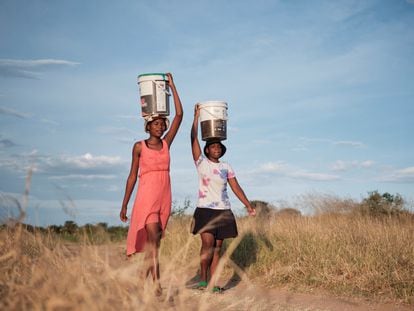 Residents of the Pumula East municipality, in Zimbabwe, walk to get water in the midst of a severe drought.