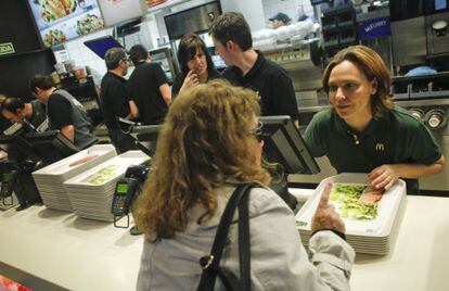 Patricia Abril, president of McDonald's España, listens to a customer in a Madrid franchise.