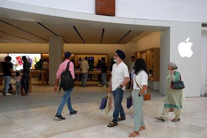 A group of people walk past a newly-opened Apple store in New Delhi – the second of its kind in India – in early-June of 2023
