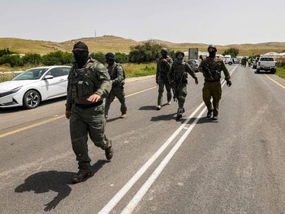 Israeli gather near the Hamra junction in the northern part of the Jordan valley in the occupied West Bank following a shooting attack on April 7, 2023