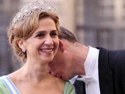 Iñaki Urdangarin kisses his wife Cristina at a royal wedding in Sweden in 2010.