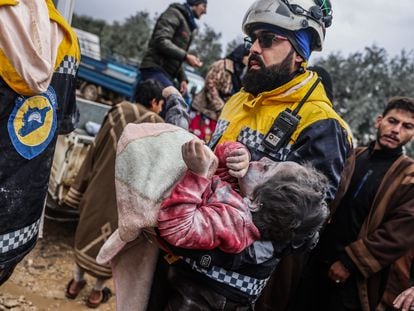 Members of Syria's White Helmets transported the body of a child after the earthquake on Monday.