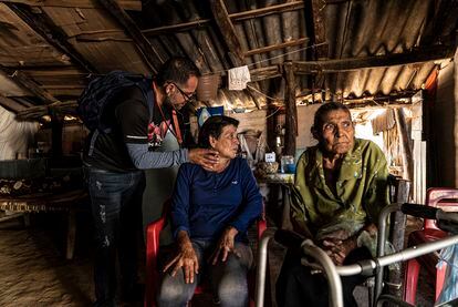 María Zavala receives medical attention beside her aunt at her home in Jesús María.

