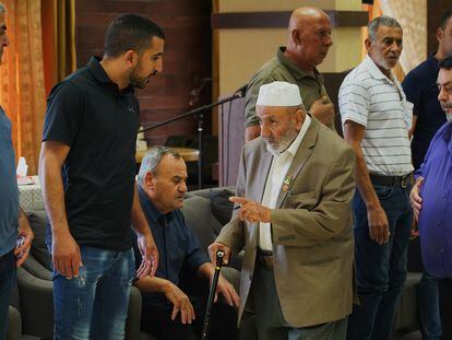 Basel (left) receives condolences at the funeral for his father, an Arab-Israeli construction worker who died on Sunday in an attack by Hezbollah.