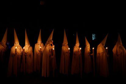 Penitents of La Paz Brotherhood during a procession in Seville on April 14, 2019.
