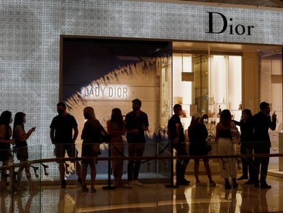 People form a line outside a Dior store in Singapore as the city state reopens the economy amid the coronavirus disease (COVID-19) outbreak, June 19, 2020.