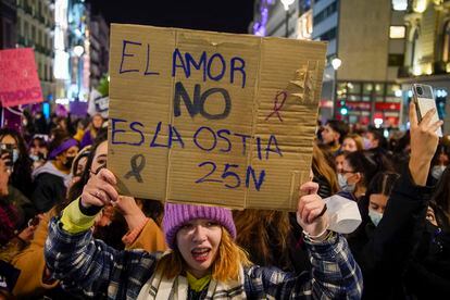 A protester in Madrid holds a sign with the message: “Love is not pain.”