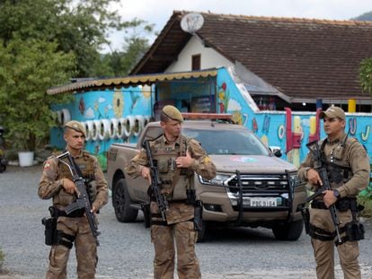 Security forces stand guard outside the private preschool where an attacker killed four children with a bladed weapon, in Blumenau, Santa Catarina State, in southern Brazil, on April 5, 2023.